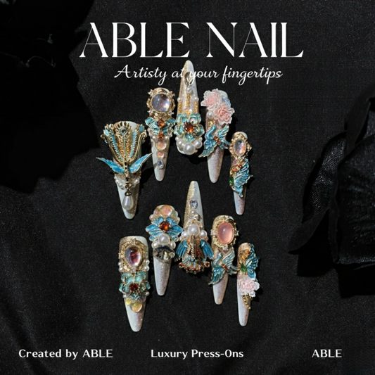 Decorative nail art with gemstones and flowers on a black background, featuring the brand 'ABLE'.