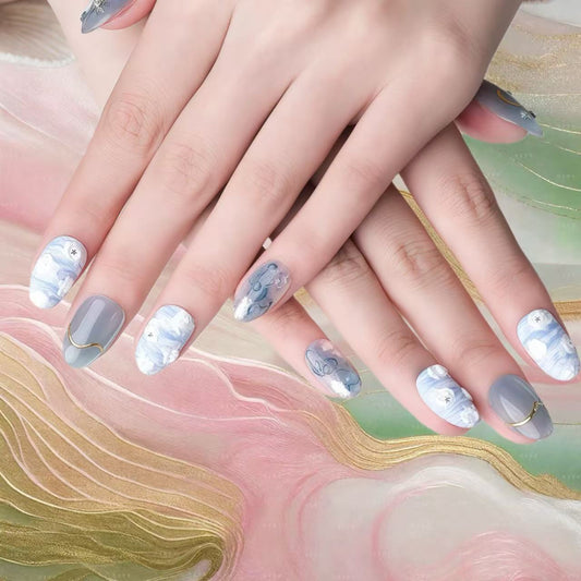 Close-up of hands with decorative nail art on a colorful abstract background