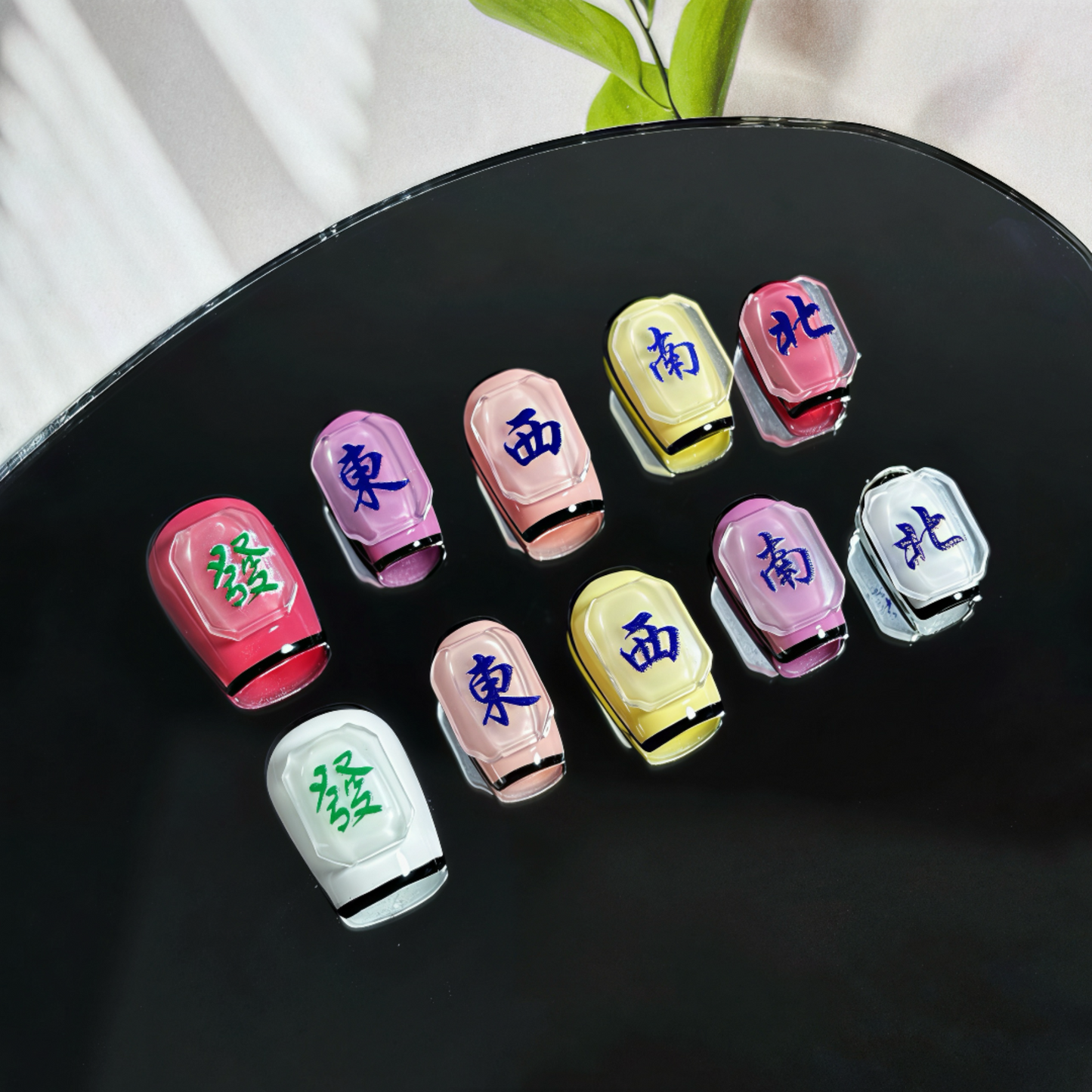 Colorful Japanese zodiac charms on a black surface