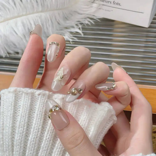 Close-up of a hand with decorative nails holding a feather