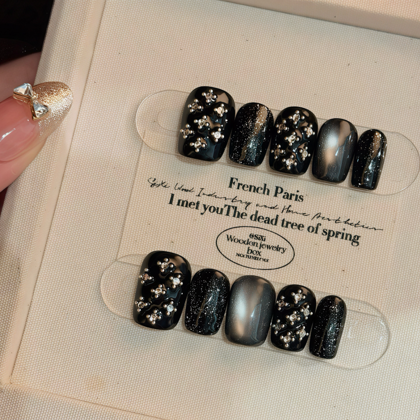Set of black and silver glittery nail art on a display card with text