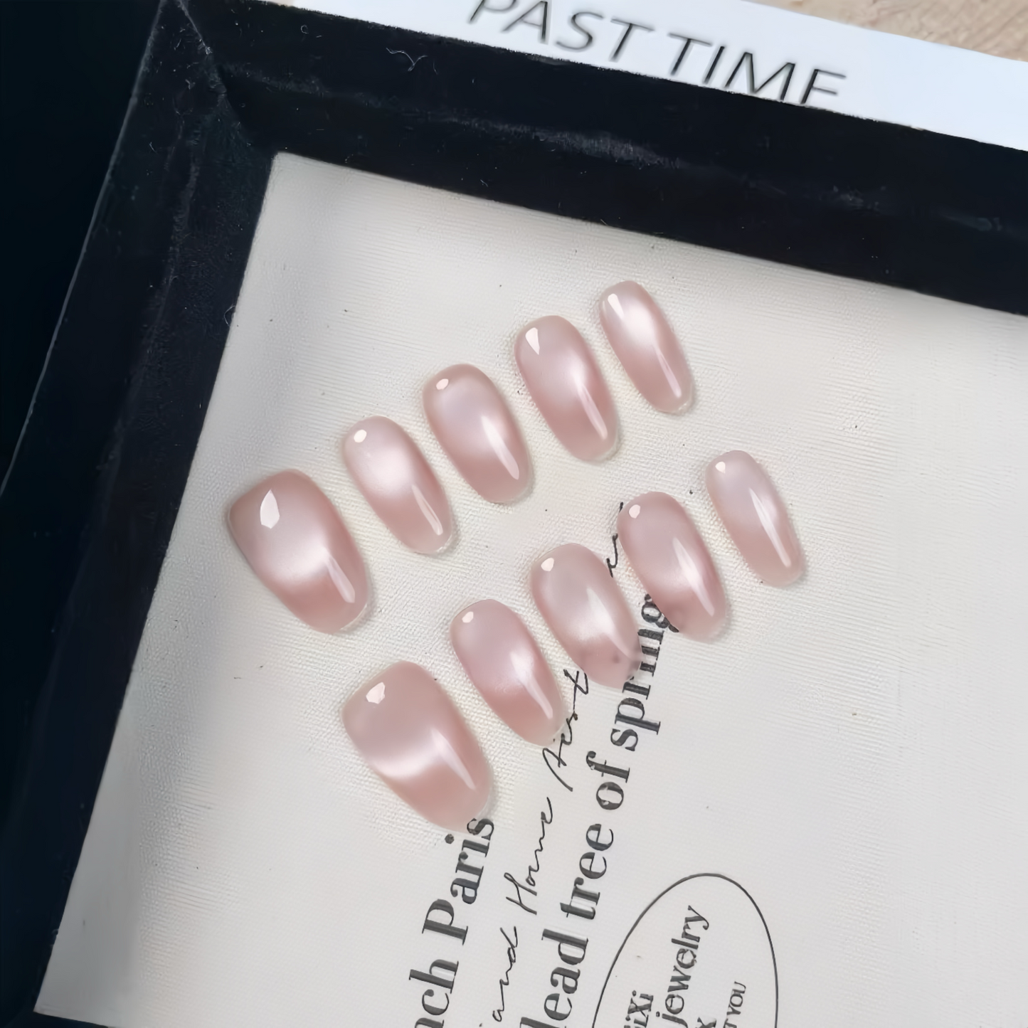 Set of pink nail art designs on a white surface with text