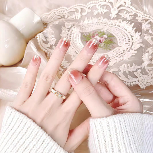 Close-up of hands with pink nail polish on a decorative lace background