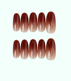 Set of brown ombre nail extensions on a white background