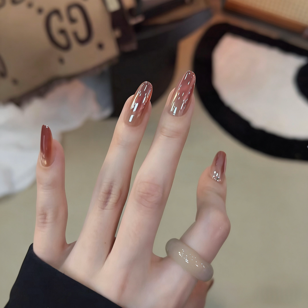 Close-up of a hand with polished nails in a blurred indoor setting