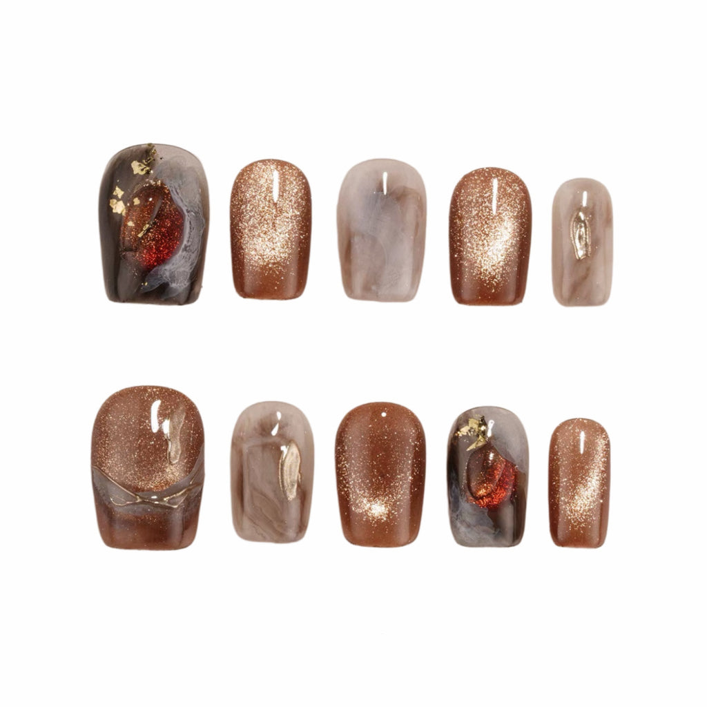 Set of nail art designs with metallic and glittery finishes on a white background