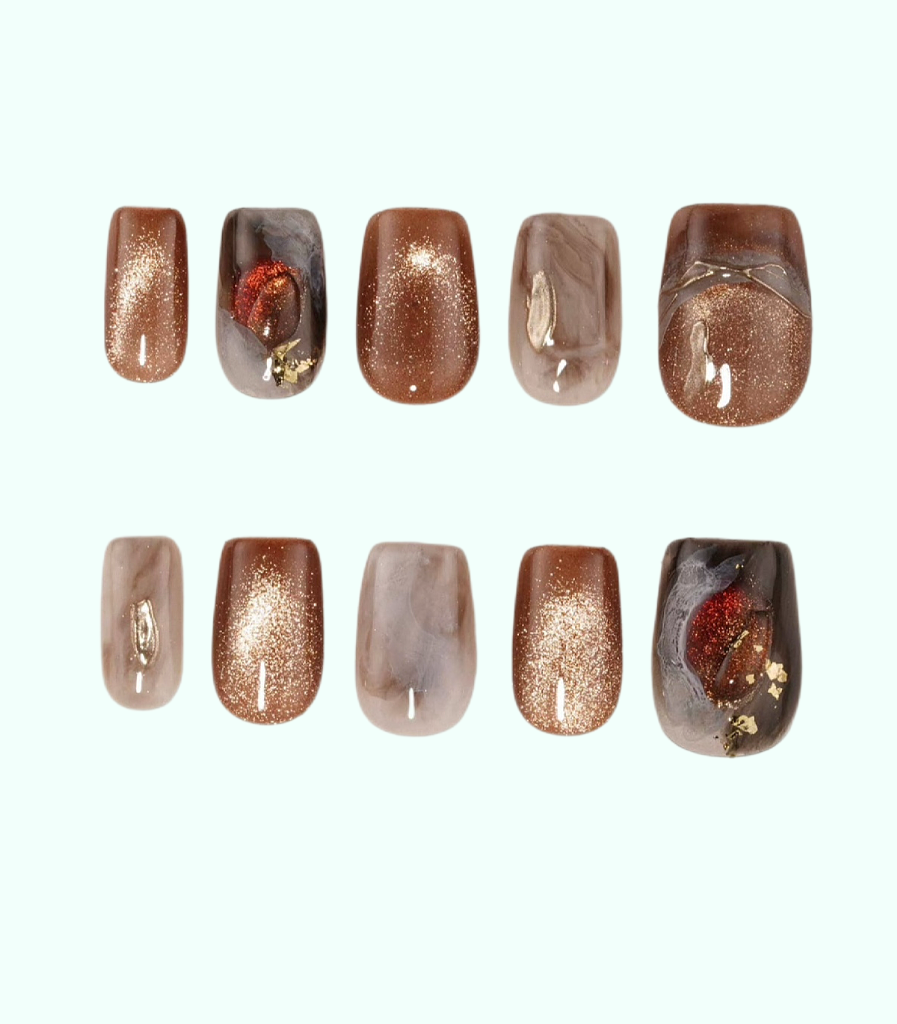 Set of nail art designs with metallic and glittery finishes on a white background