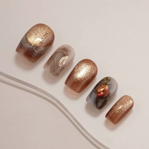 Set of five nail designs with glittery finishes on a light background