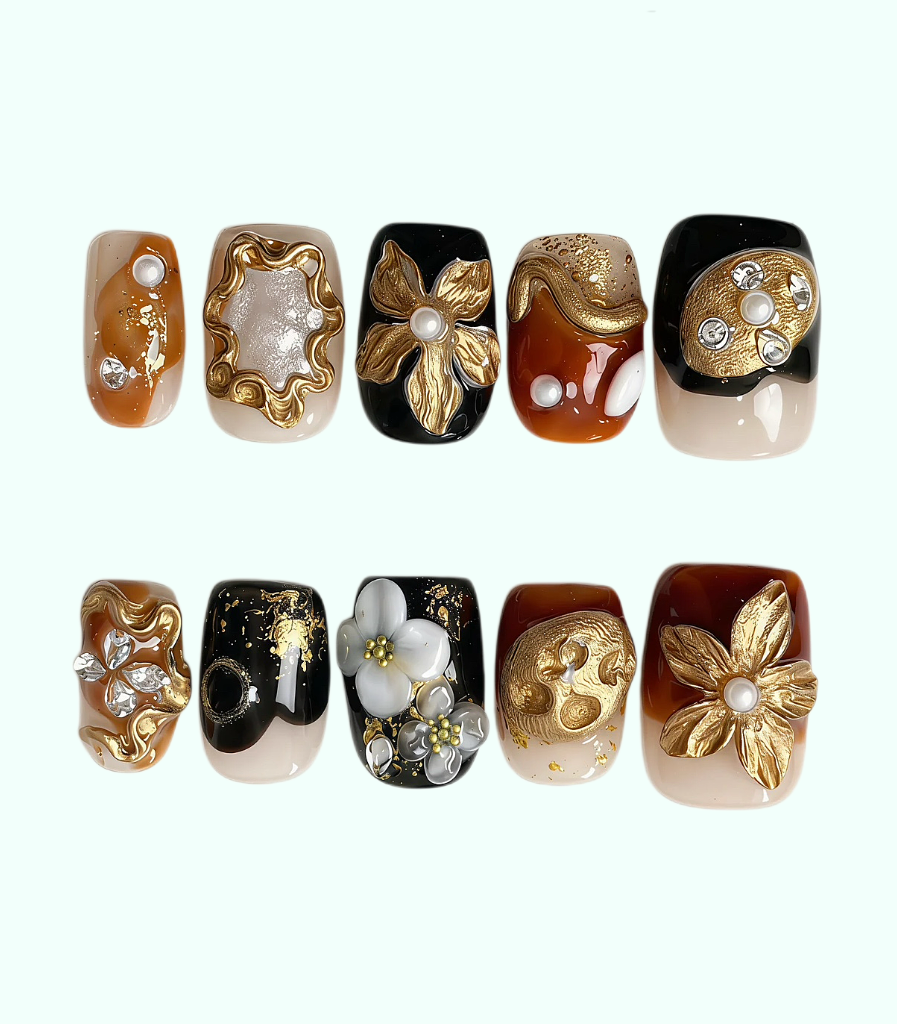 Set of nail art designs with gold, black, and white elements on a white background