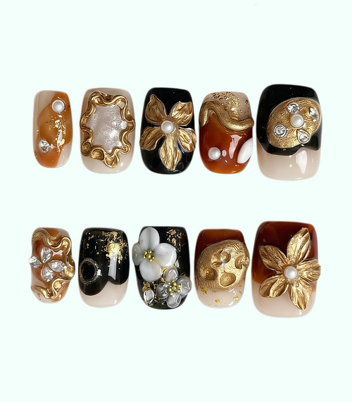 Set of nail art designs with gold, black, and white elements on a white background