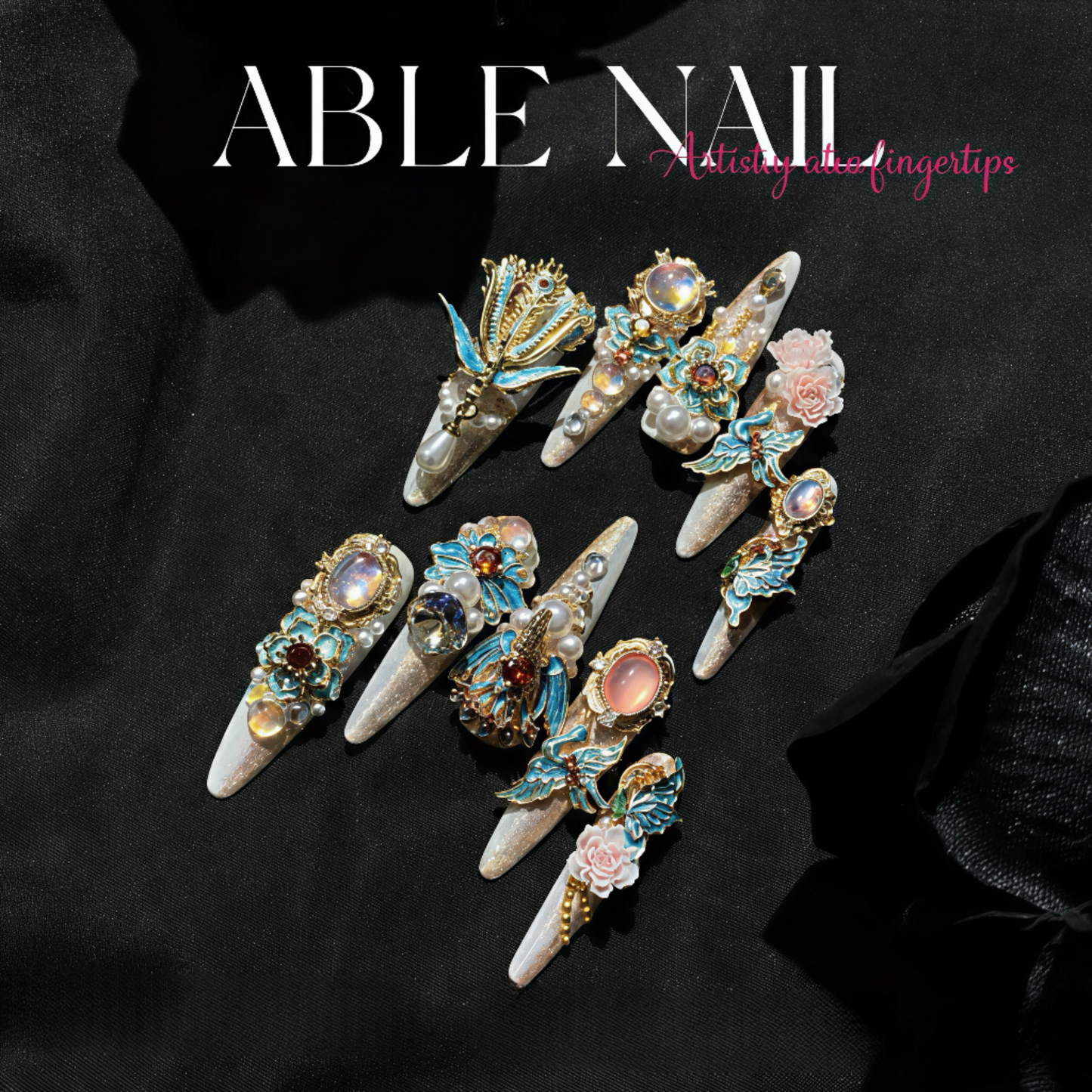 Decorative nail art tips with gemstones on a black background, featuring the brand 'ABLE NAIL'.