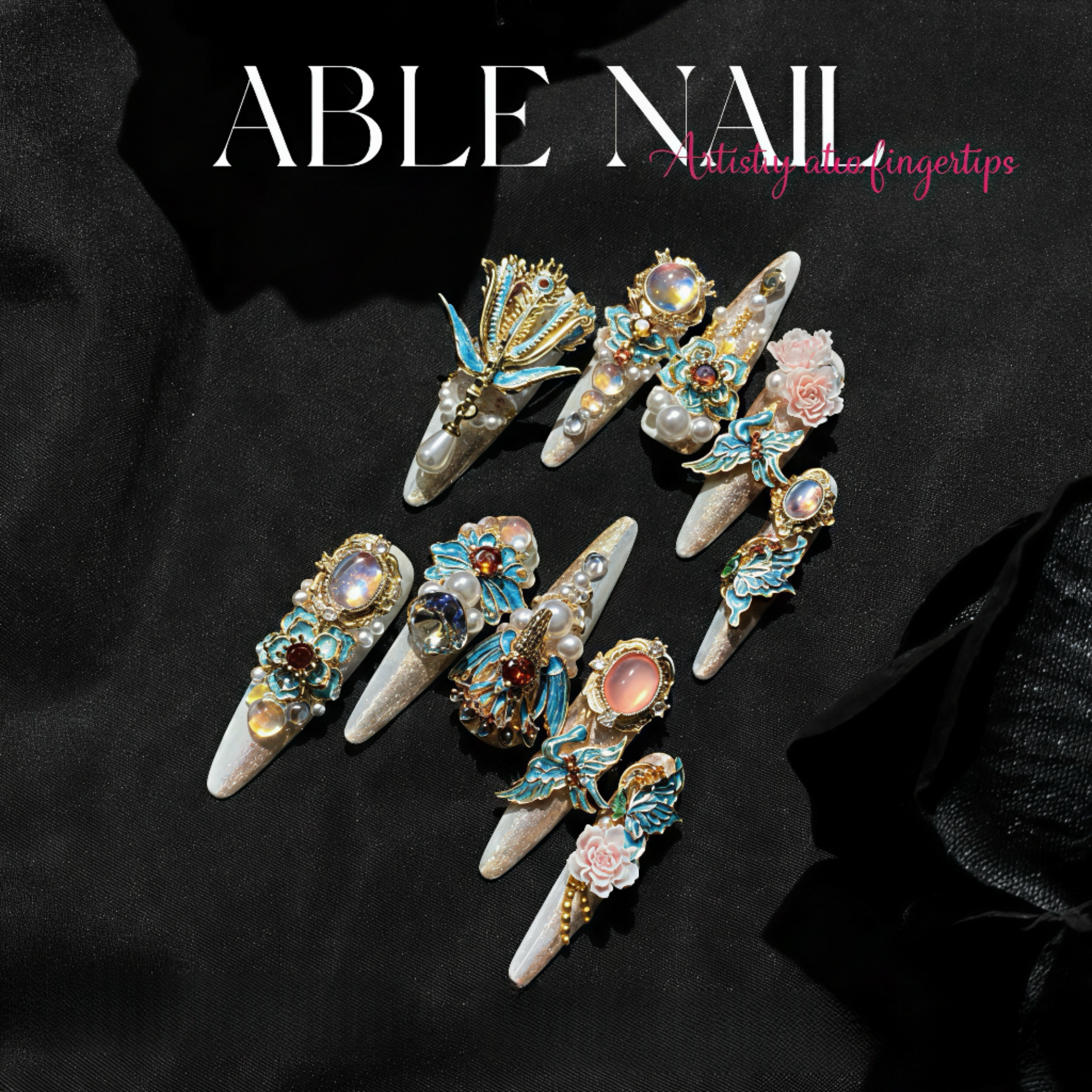 Decorative nail art tips with gemstones on a black background, featuring the brand 'ABLE NAIL'.