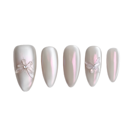 Set of five decorative nails with floral designs on a white background