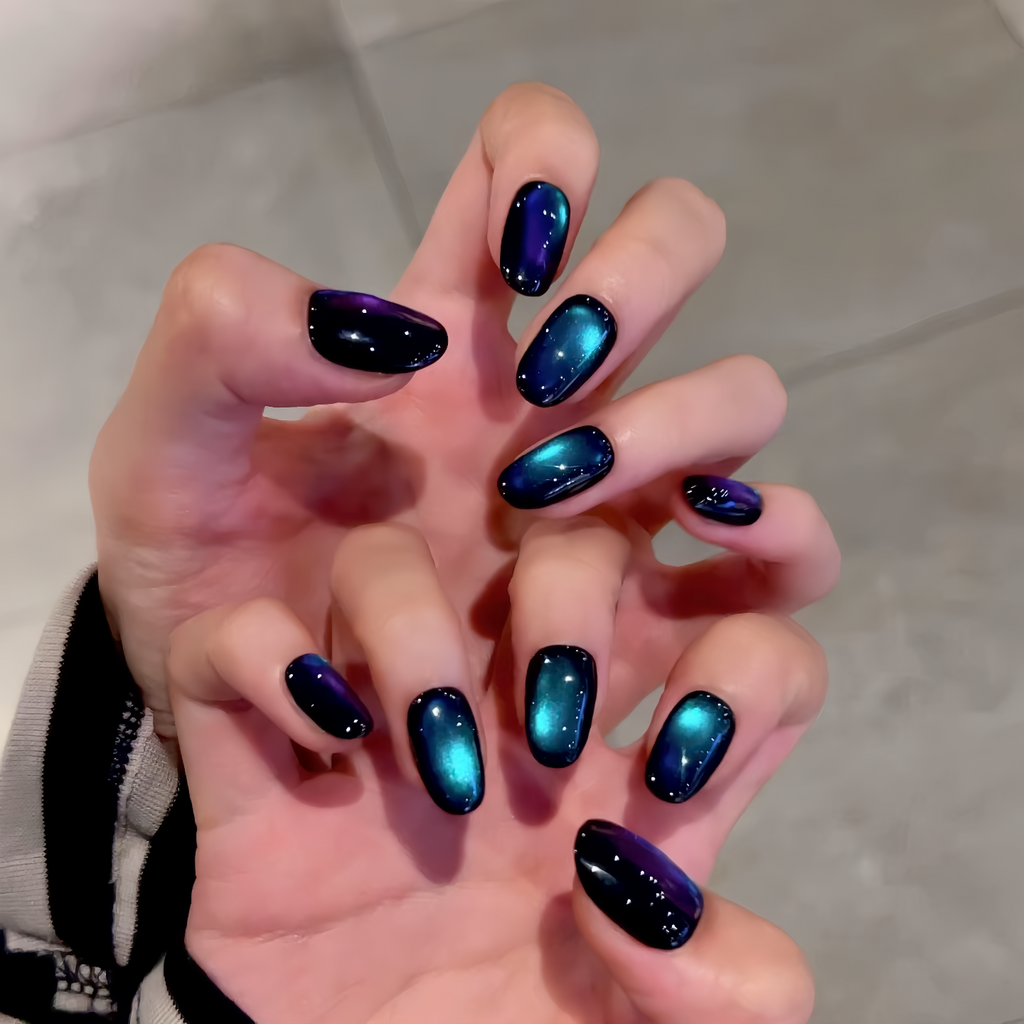 Hand with galaxy-themed nail art on a neutral background