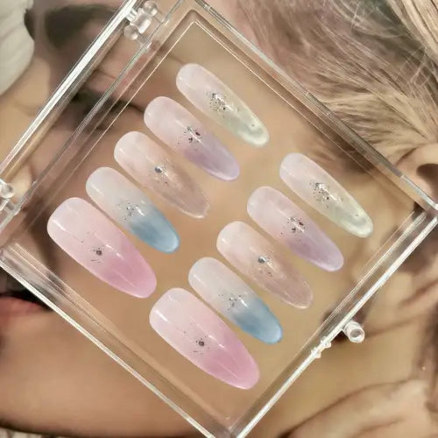Set of pastel-colored nail samples in a clear display case.