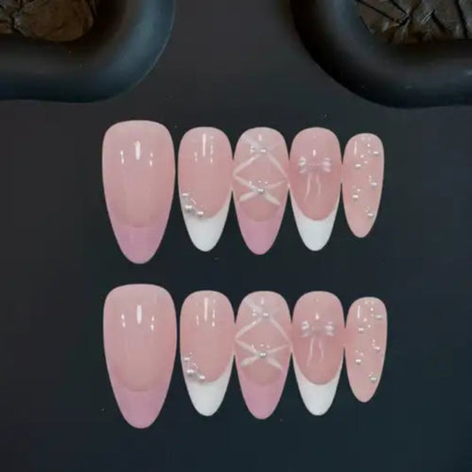 Set of pink and white gradient nail designs on a dark background