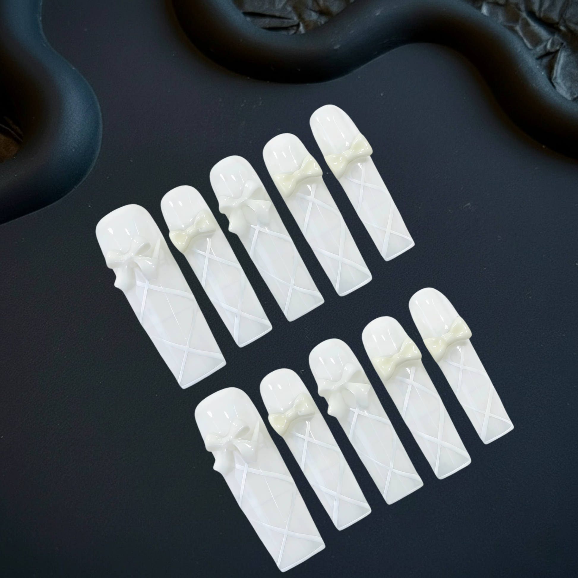 Set of white plastic components on a black surface