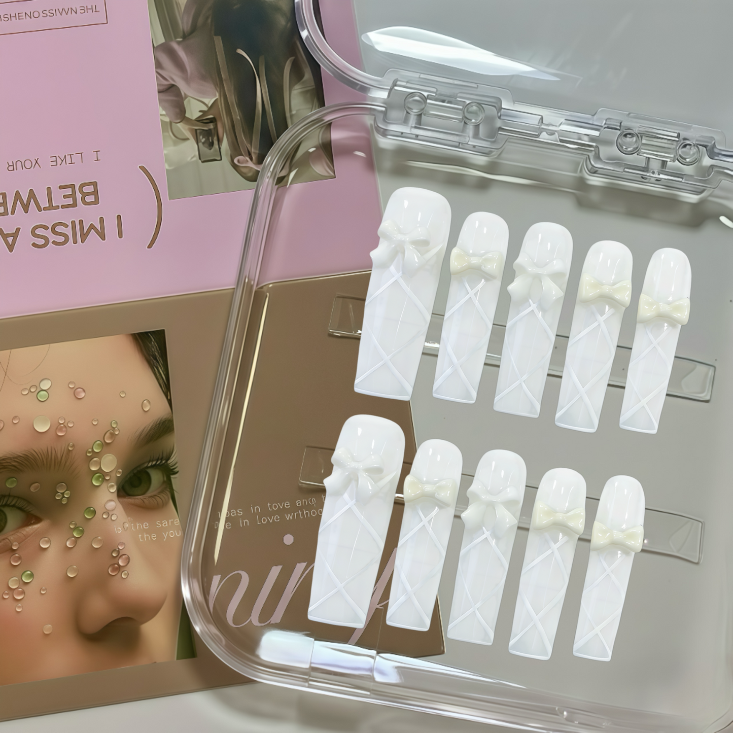 Set of false nails with a clear case on a magazine background