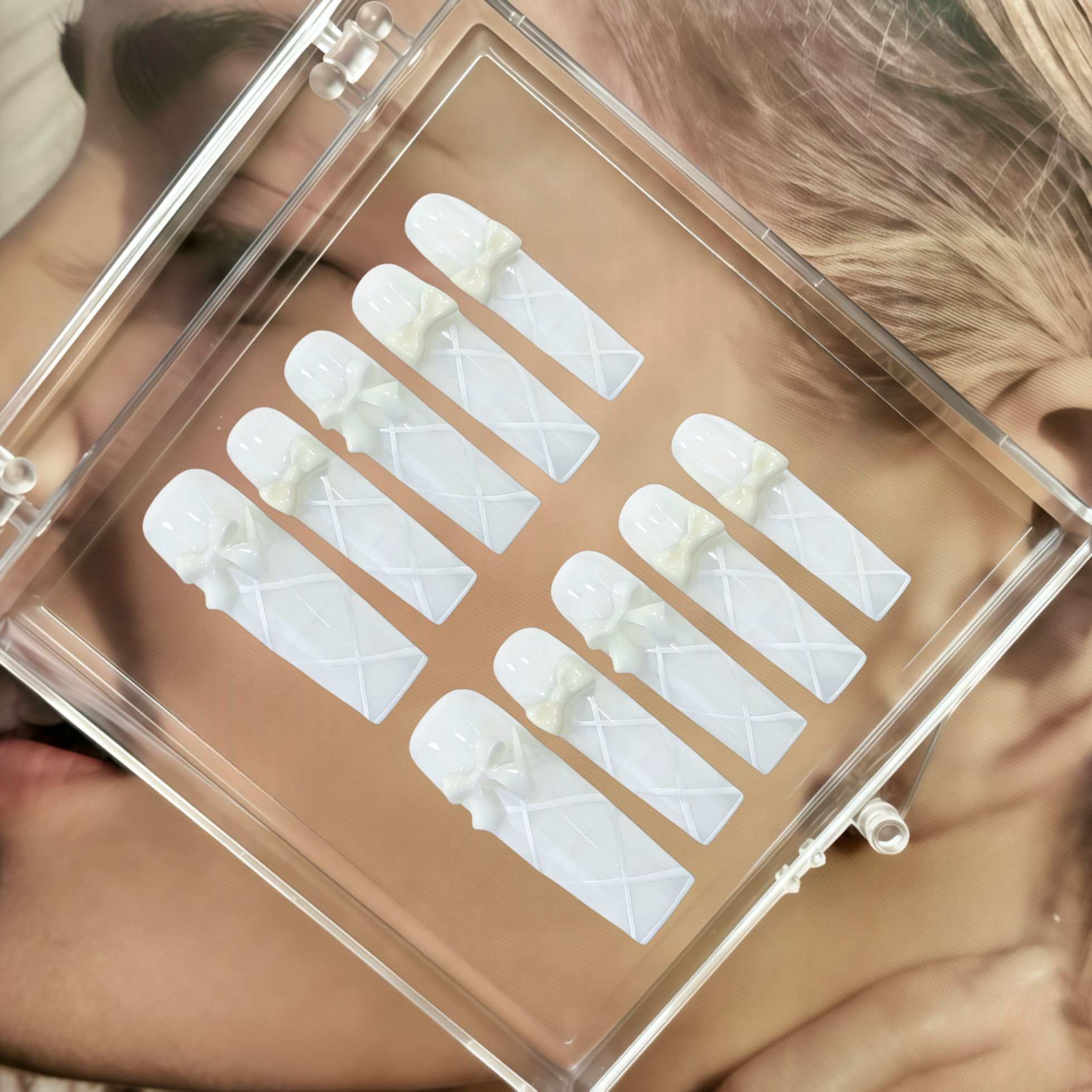 Eyelash extensions in a clear case held by a person with blonde hair.