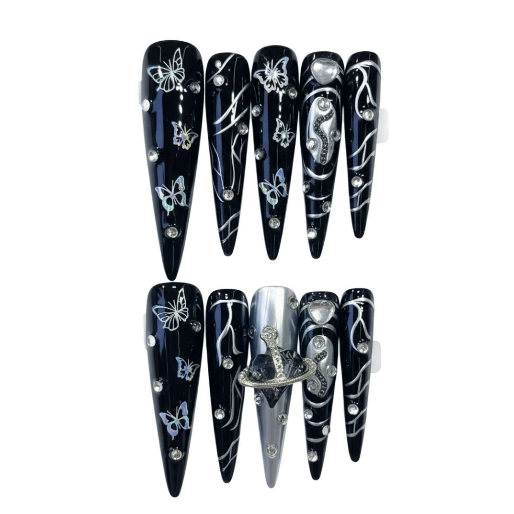 Black nail extensions with butterfly and heart designs on a white background