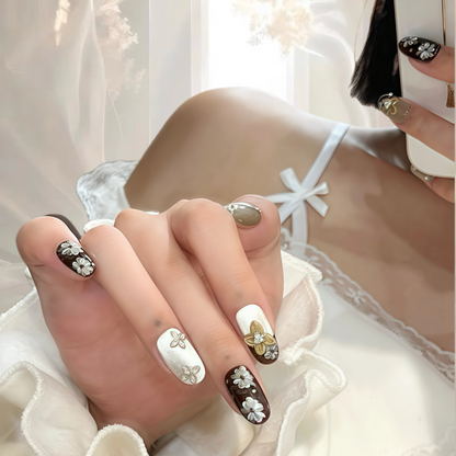 Close-up of hands with decorative nail art against a blurred background