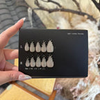 Black case with white pinecone-shaped items held by a hand against a blurred natural background