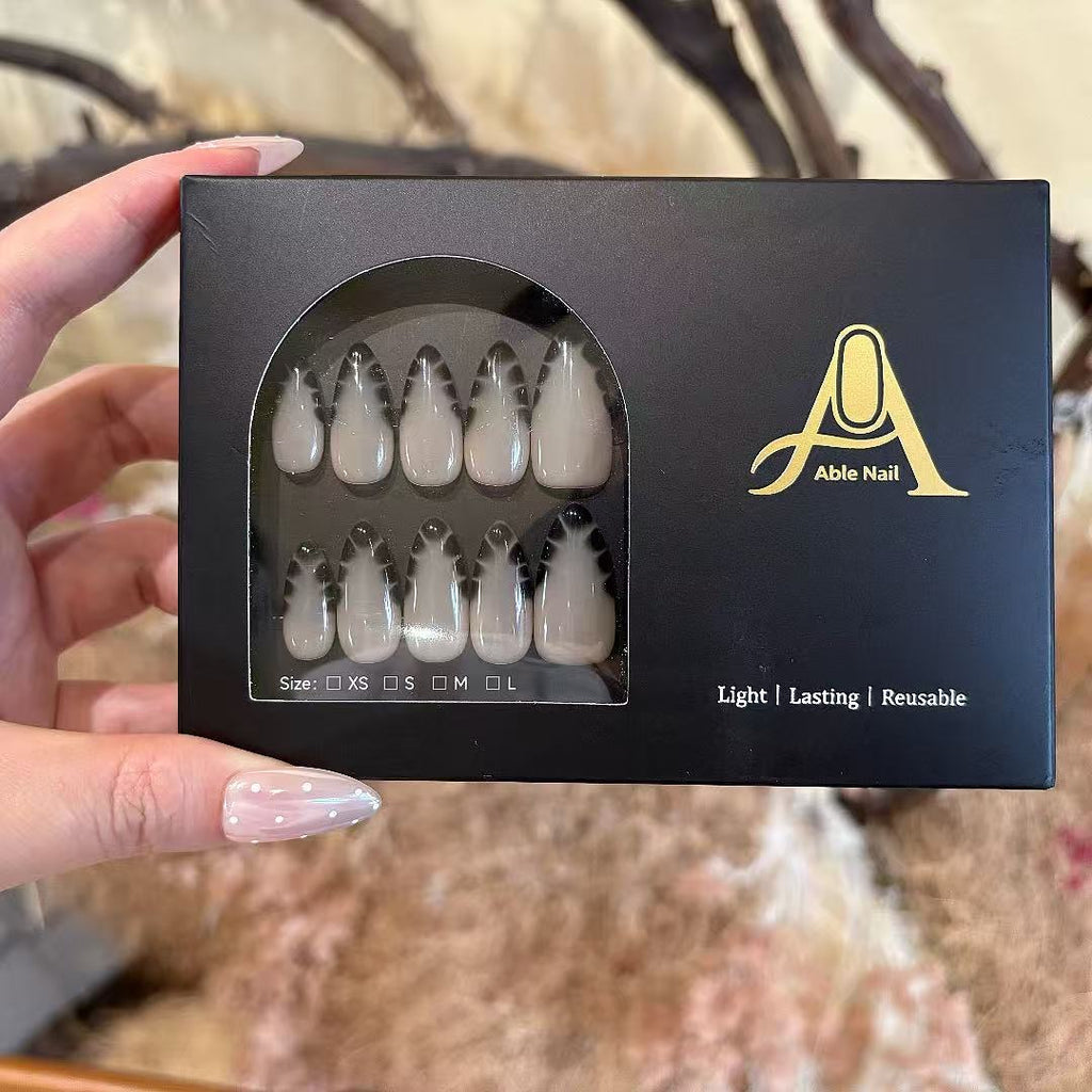 Box of Able Nail products held by a hand with a blurred natural background