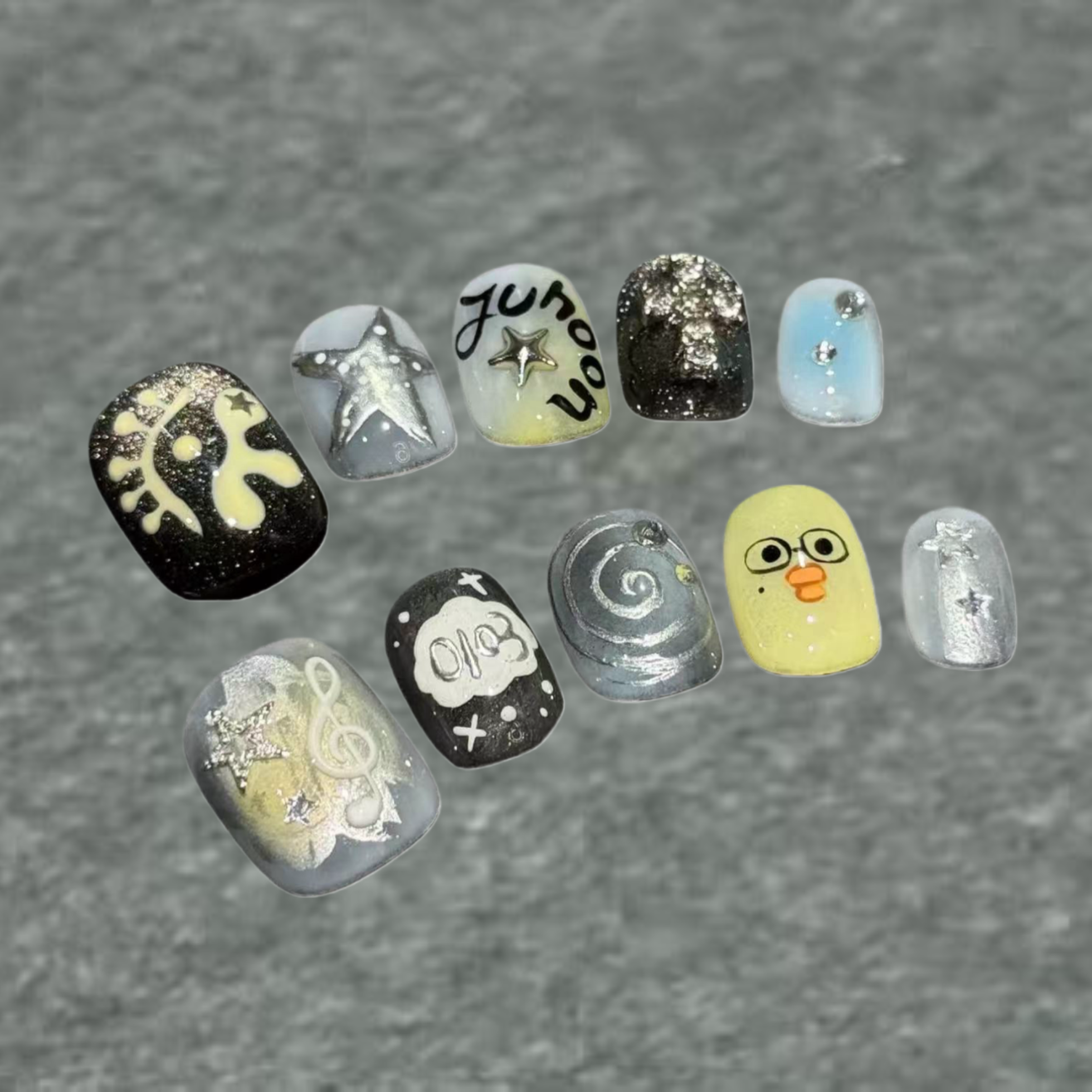 Collection of variously designed nail art samples on a gray background