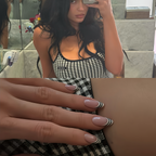 Woman taking a mirror selfie wearing a black and white checkered dress, with a close-up of her hands showing nail polish.