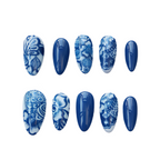Set of blue and white patterned nail designs on a white background