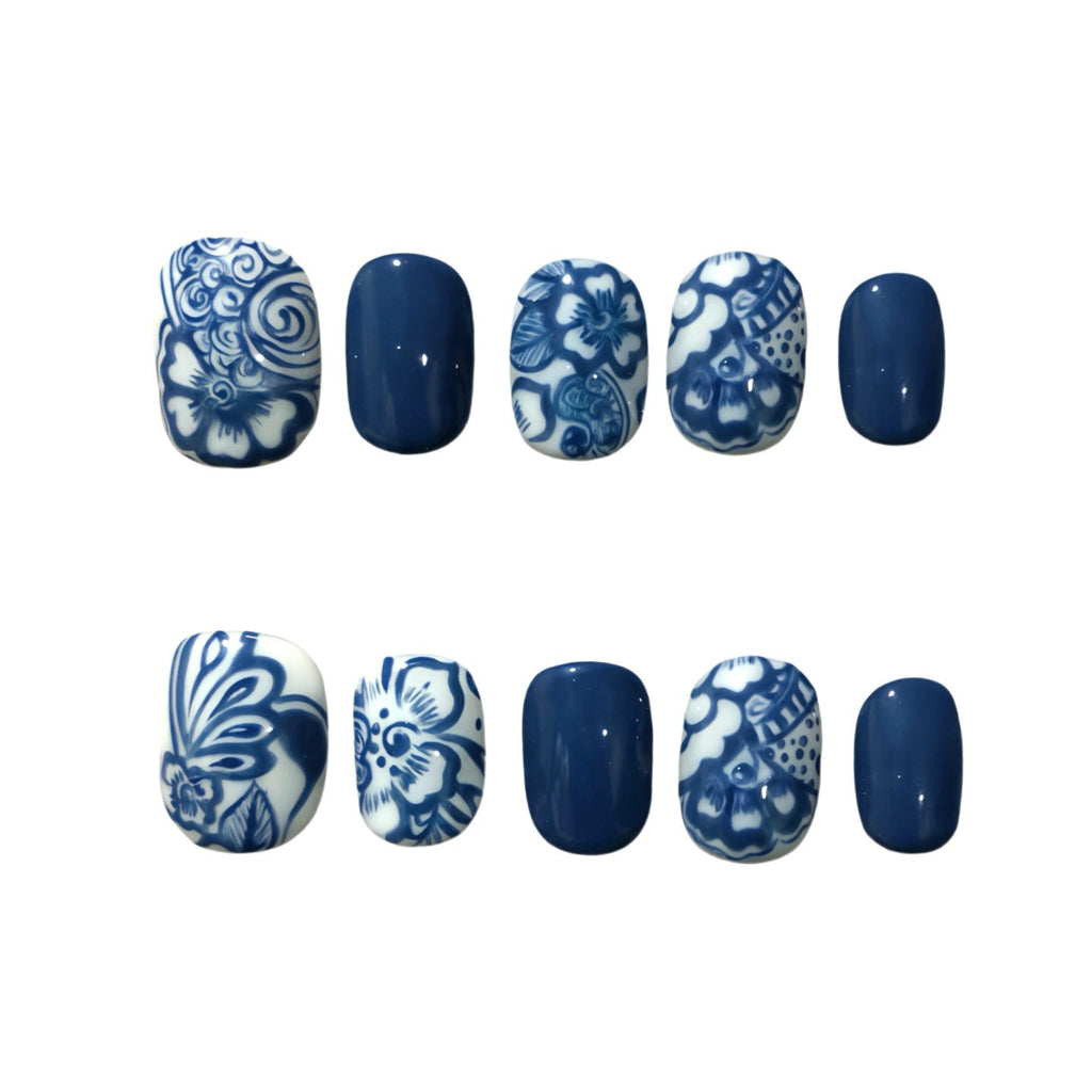 Nail art designs with blue and white patterns on a white background