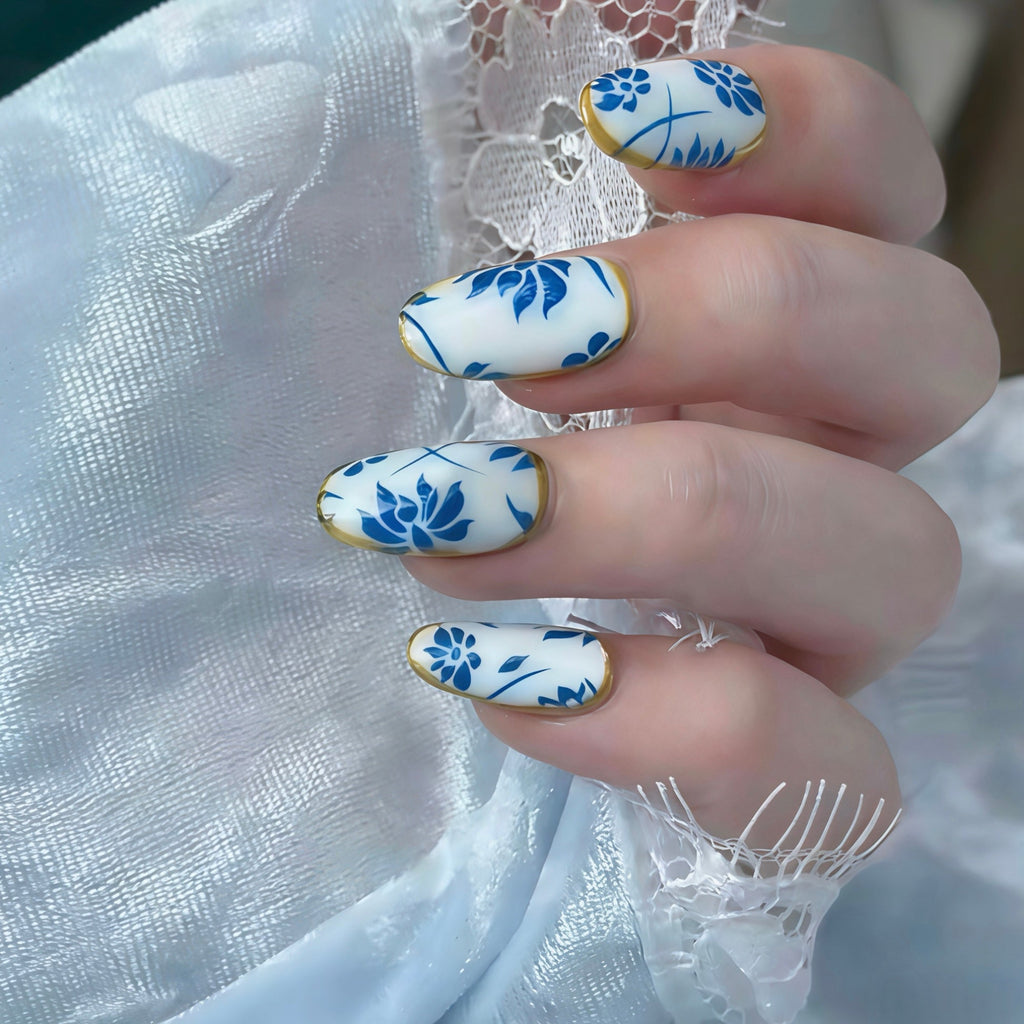Nails with blue floral design on a white lace background