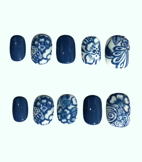 Nail art designs with blue and white patterns on a white background