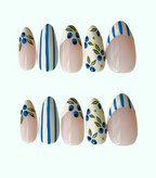 Set of decorative nail art with blue and green patterns on a white background