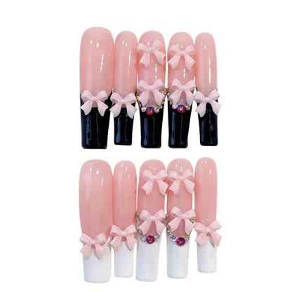 Set of decorative nail tips with pink bows and gemstones on a white background