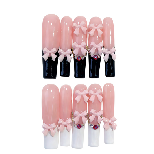 Set of decorative nail tips with pink bows and gemstones on a white background