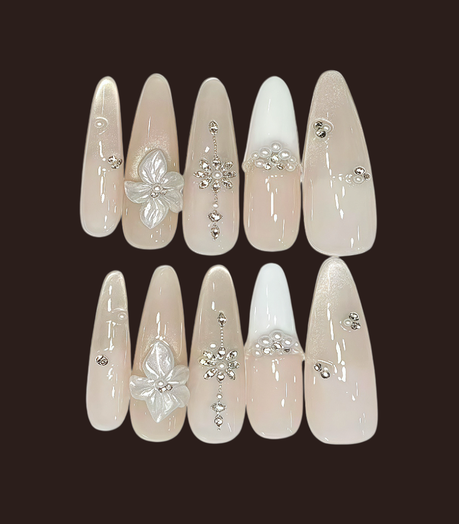 Decorative false nails with flowers and crystals on a dark background
