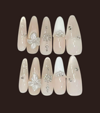 Decorative false nails with flowers and crystals on a dark background