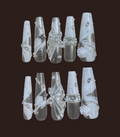 Set of decorative nail art tips with silver and white designs on a dark background