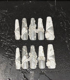 Set of decorative nail art tips on a dark textured surface