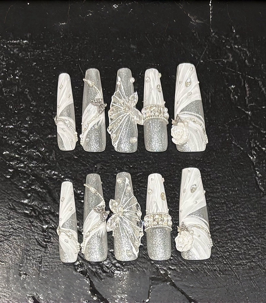 Set of decorative nail art tips on a dark textured surface