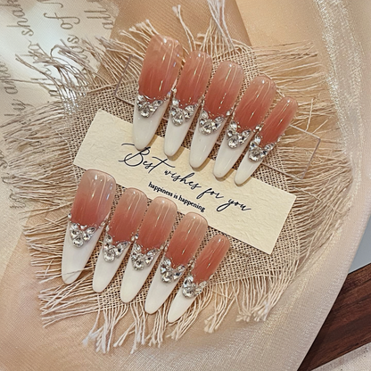 Set of decorative nails with rhinestones on a textured surface with a card.