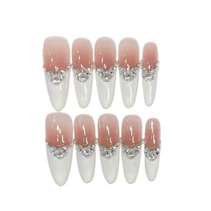 Set of false nails with pink and white design on a white background