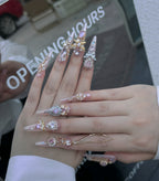 Hand wearing multiple decorative rings with a blurred background