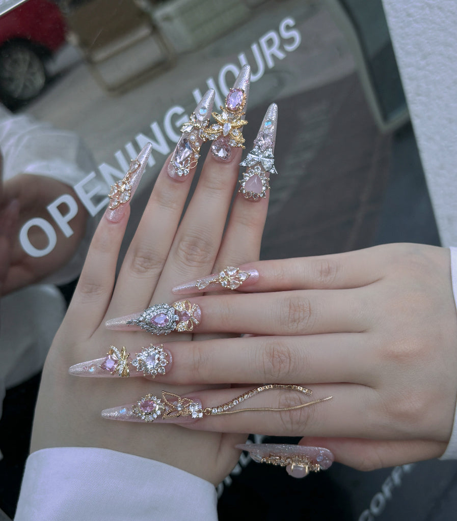 Hand wearing multiple decorative rings with a blurred background
