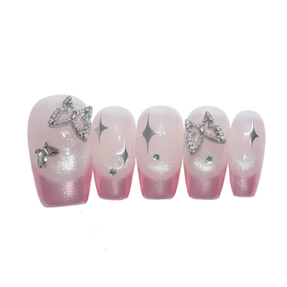 Set of pink gradient nails with decorative elements on a white background