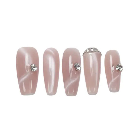 Set of five pink nail extensions with decorative studs on a white background