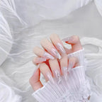 Hand with decorative nails against a white lace background