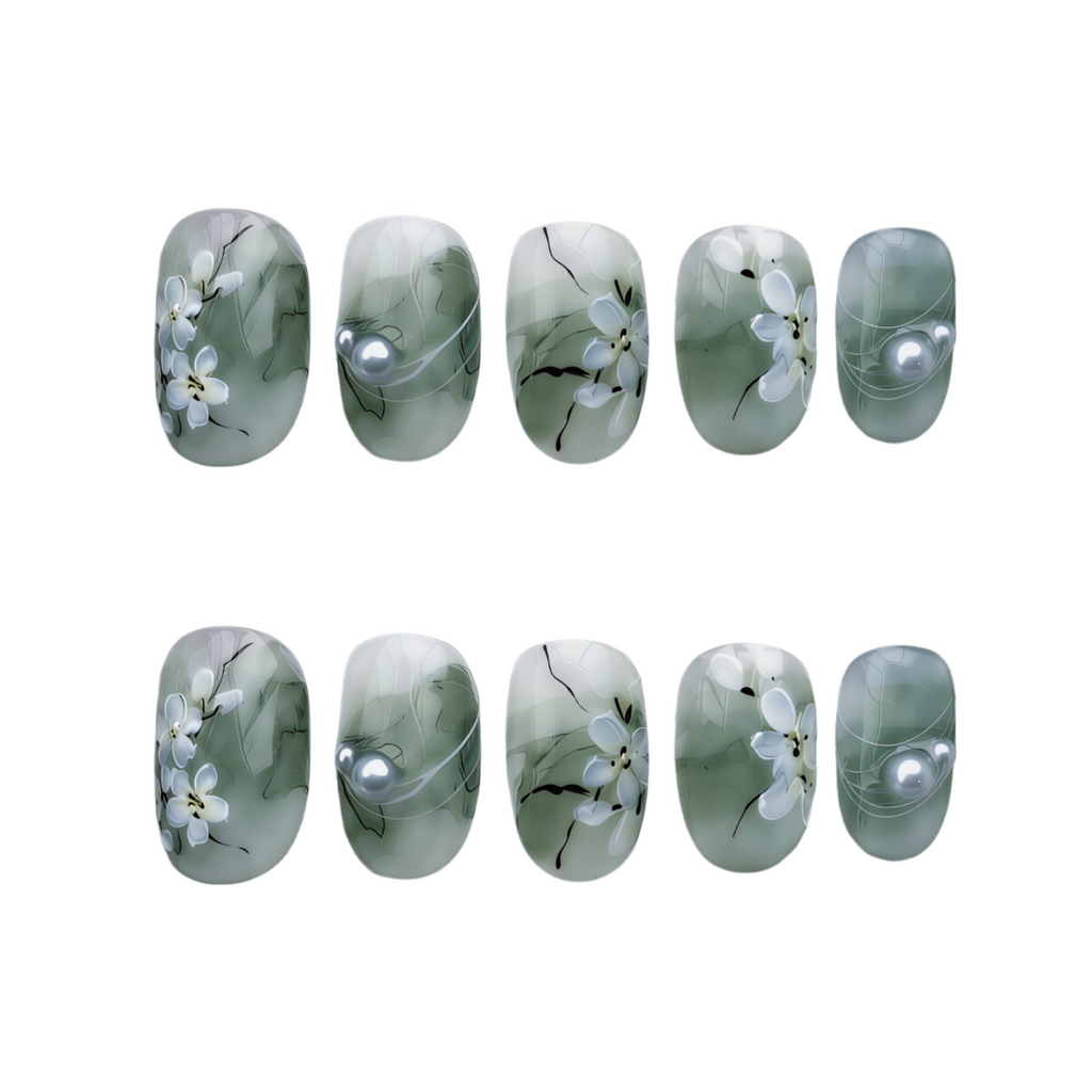 Set of green nail wraps with floral design and pearls on a white background