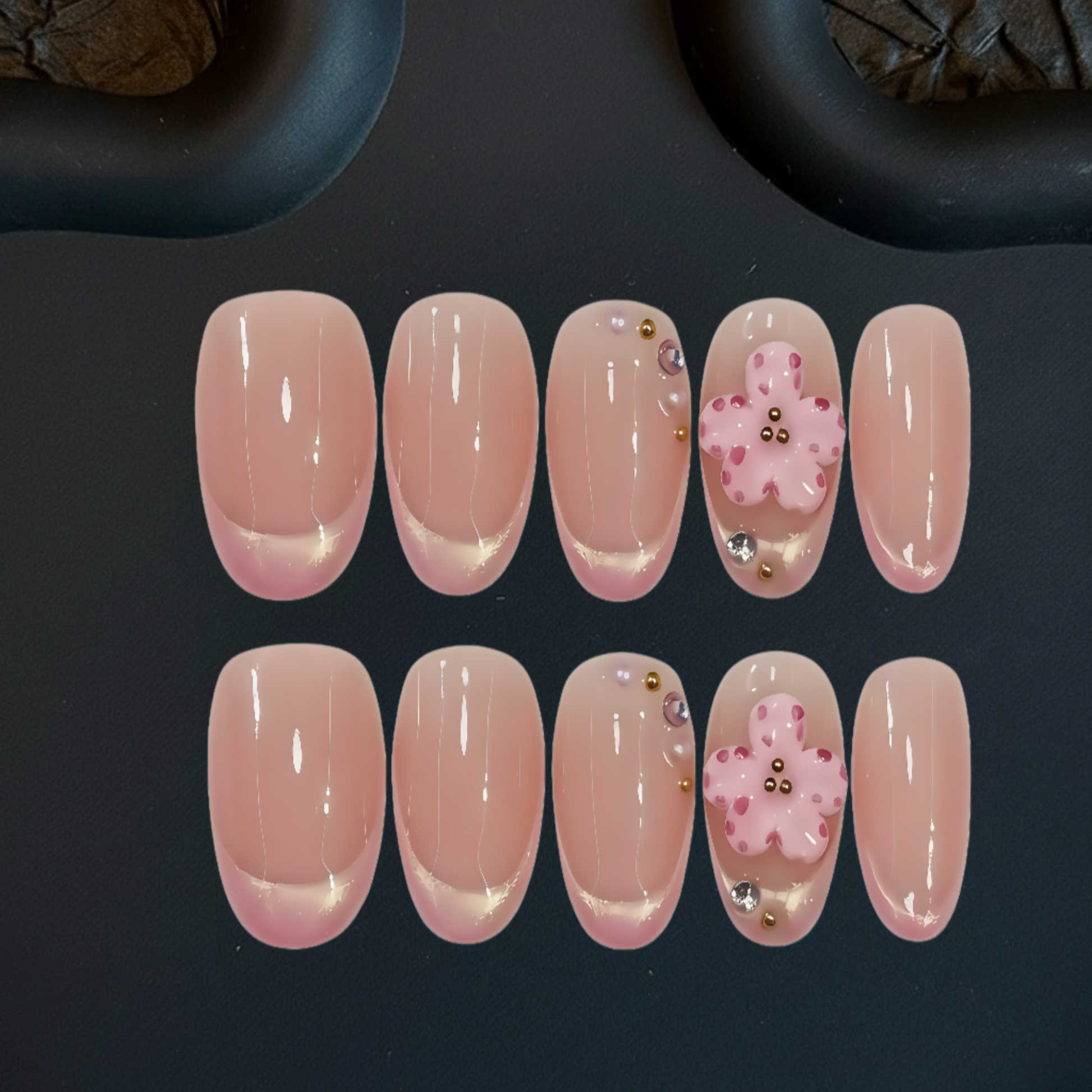 Set of pink nail designs with decorative elements on a dark background